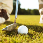 Close-up of male golfer teeing off